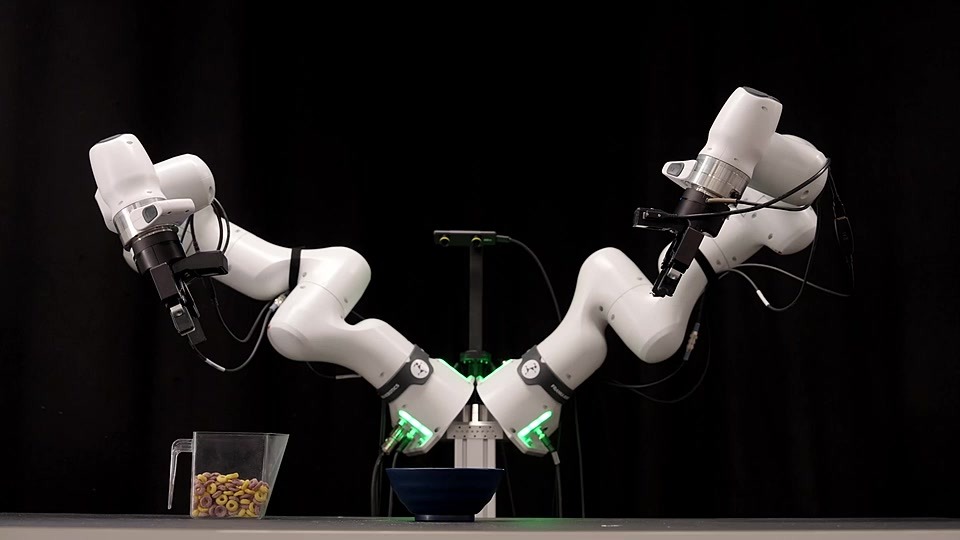 Official robot-arm demo poster showing two white arms, a cereal pitcher and a bowl