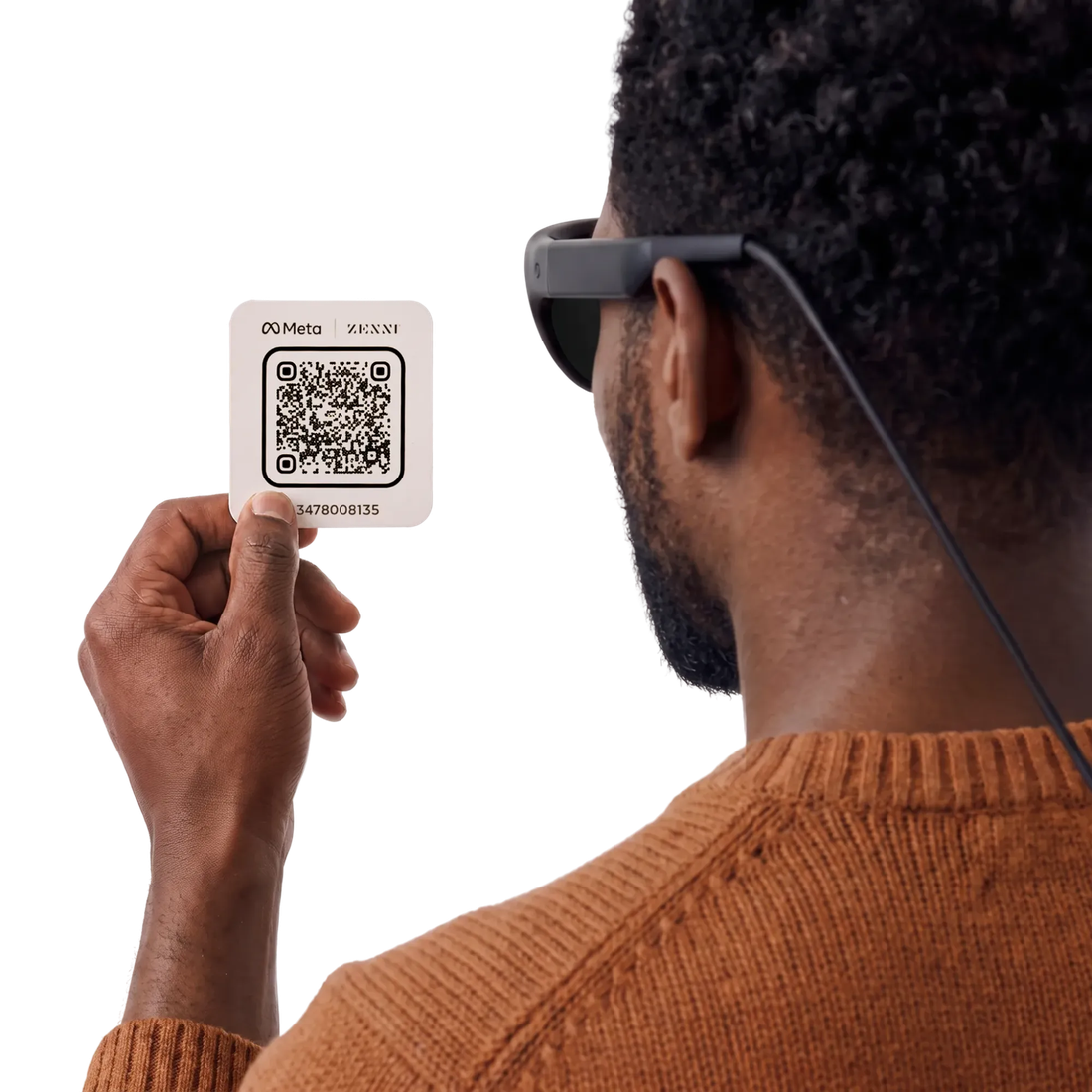 Leaked render of a person holding a Meta ZENNI QR pairing card up to the Project Phoenix glasses, cable visible