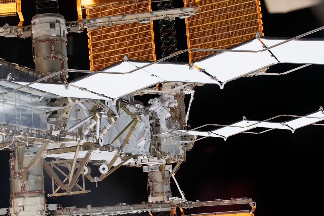 White radiator panels and golden solar arrays on the International Space Station