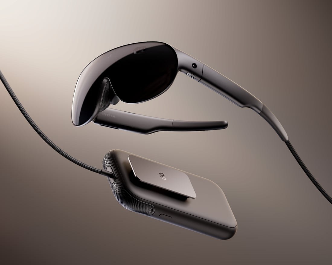 The Meta VR Glasses visor and its compute puck, connected by a braided cable, on a dark background