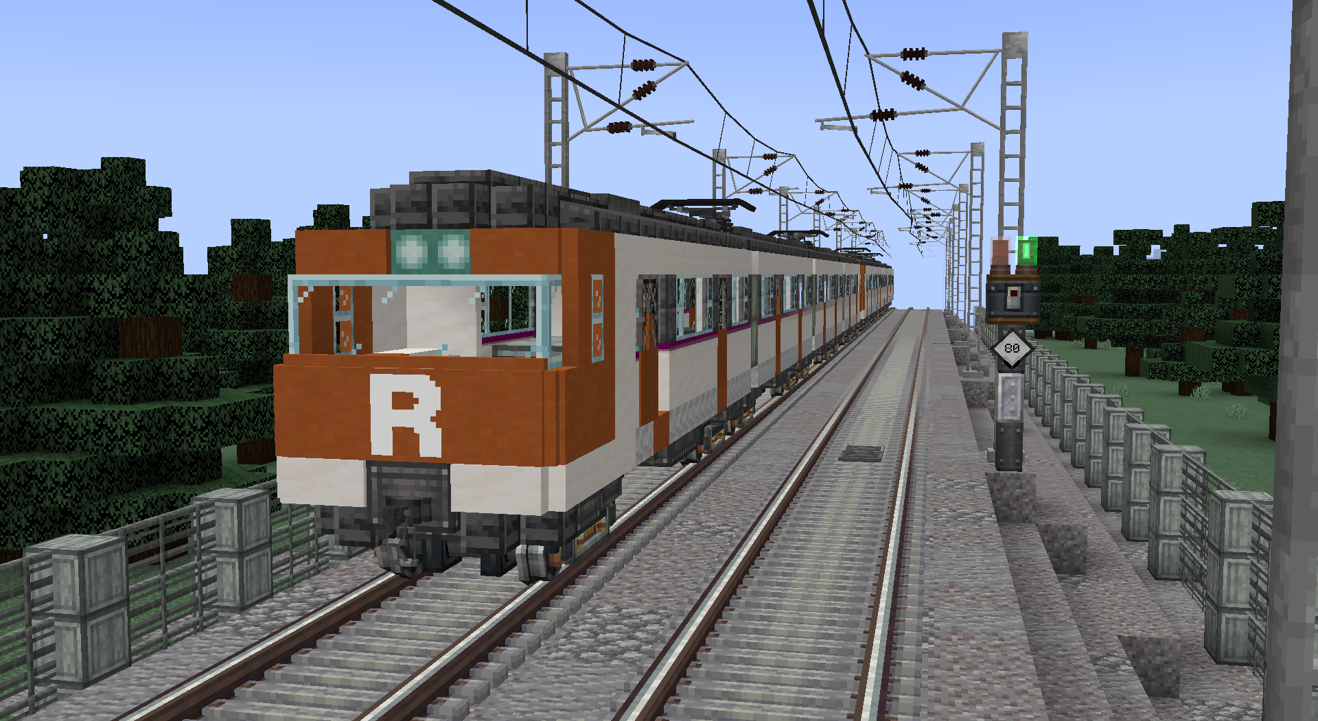 Class 447 train with the R logo running along an electrified line