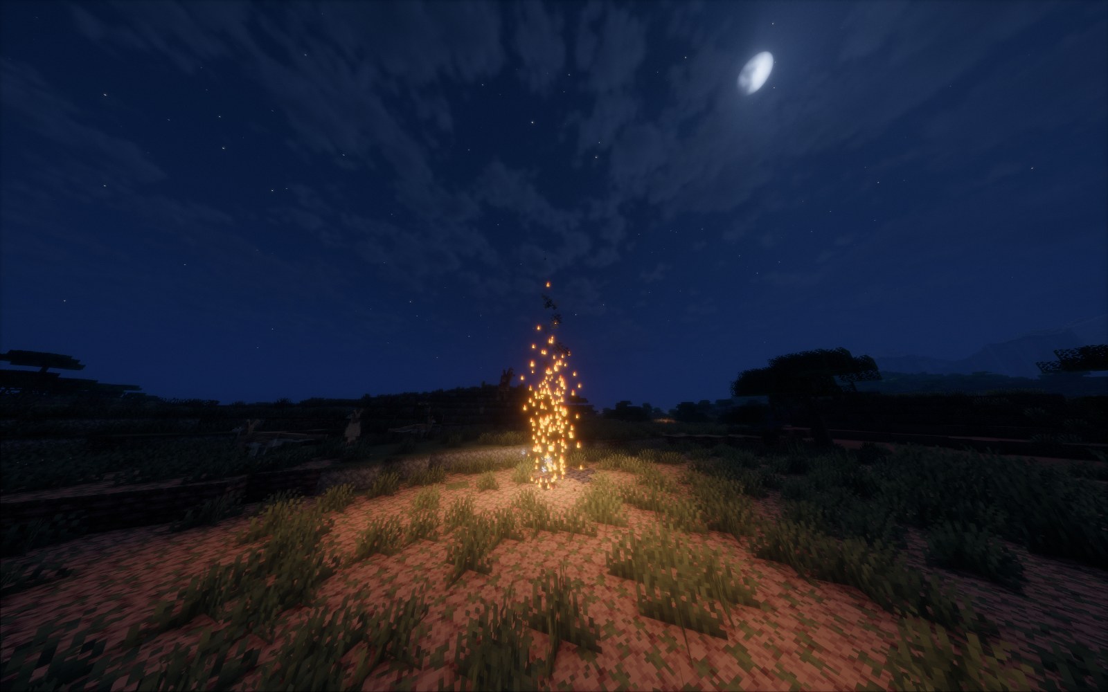 A standing flame over a gas well at night