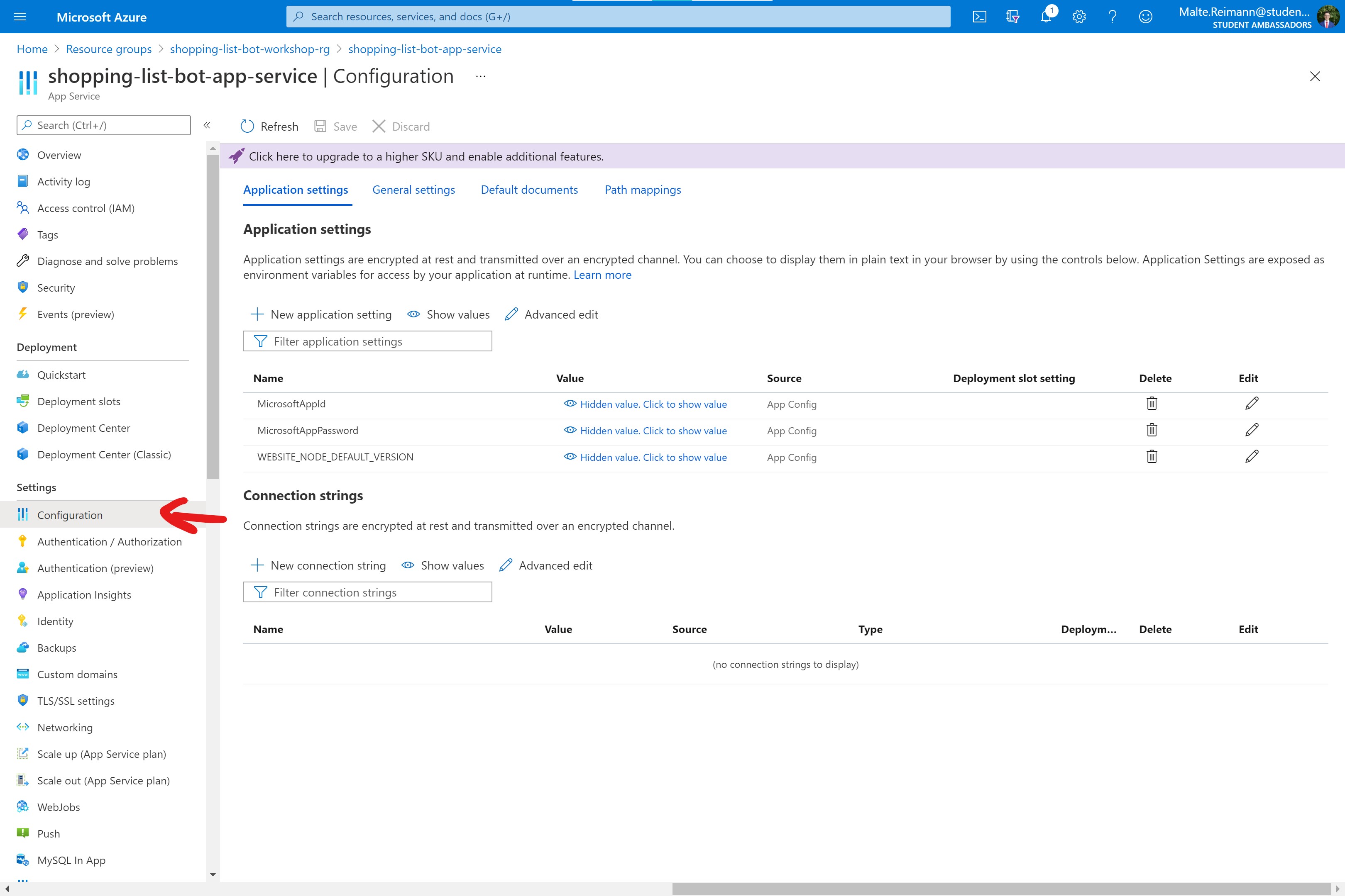 Screenshot of Azure Portal with bot App Service resource open and red arrow pointing to 'Configuration' in left side navigation.