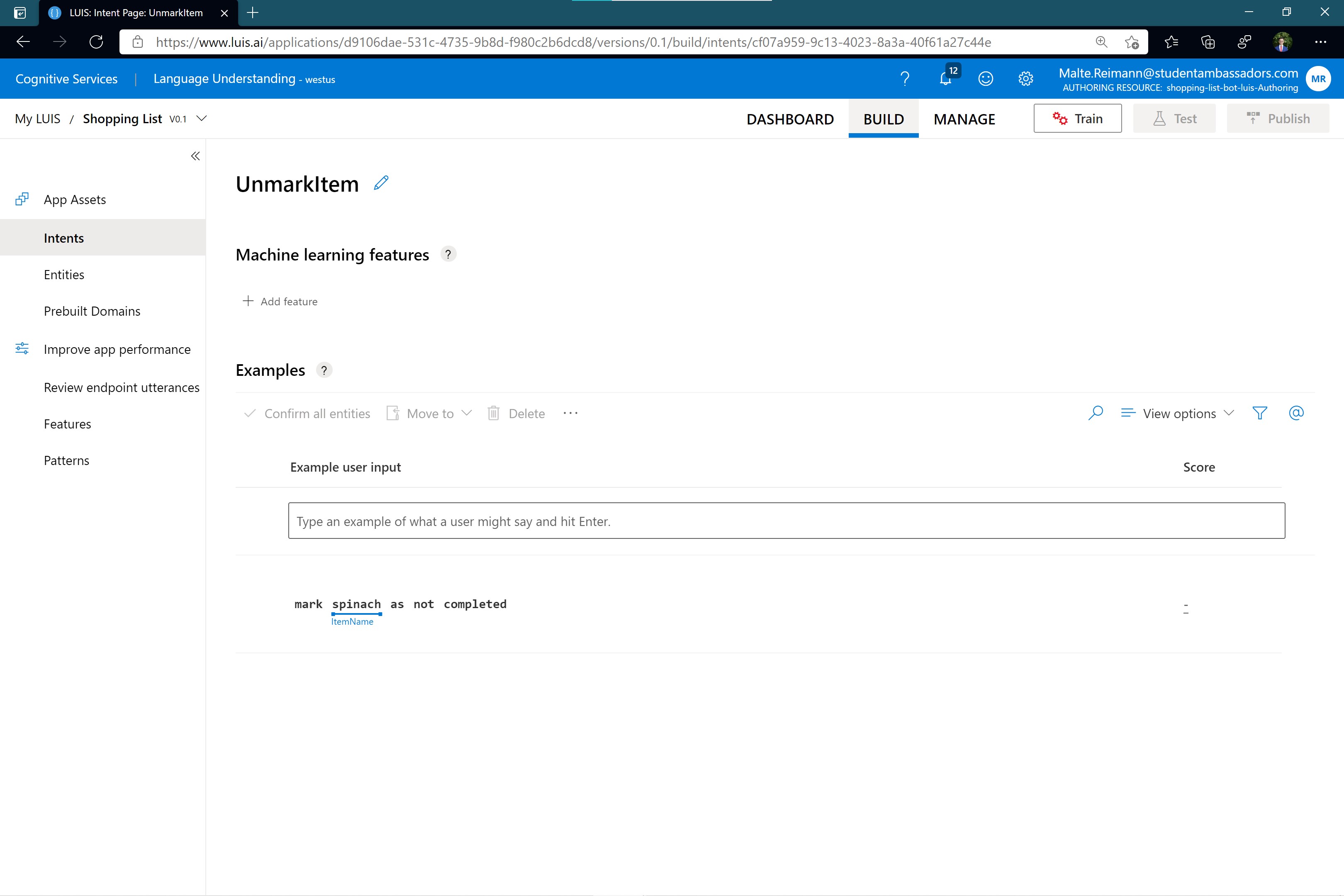 Screenshot of luis.ai 'UnmarkItem' intent page with word 'spinach' in example sentence marked as an entity of type 'ItemName'
