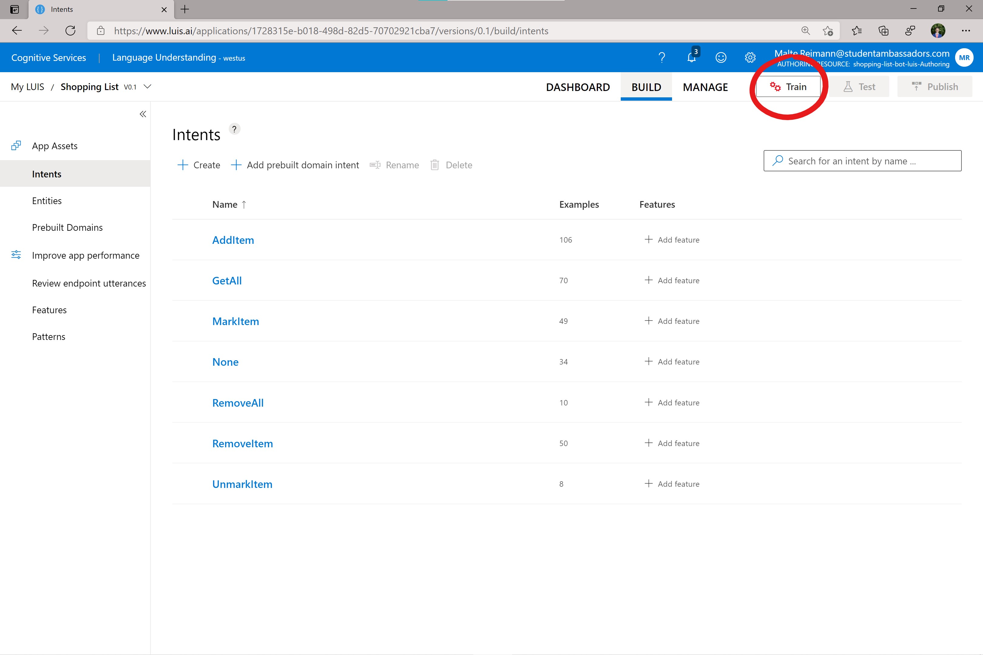Screenshot of luis.ai with a red circle around 'Train' button