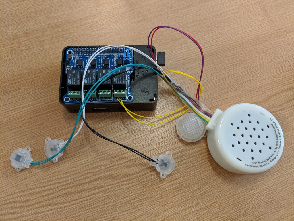 Photo of a Raspberry Pi with a relay board and the internals of a Ewan