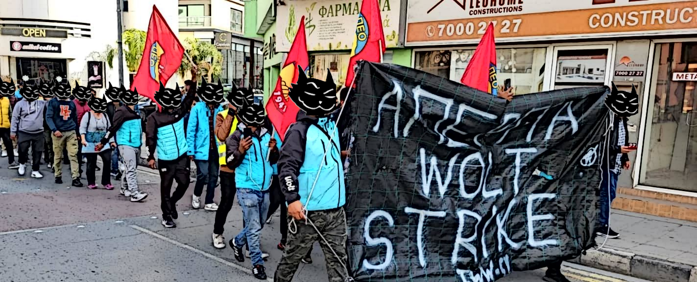 Image depicting Wolt Courier Partners striking while holding up a banner with the text Wolt Strike