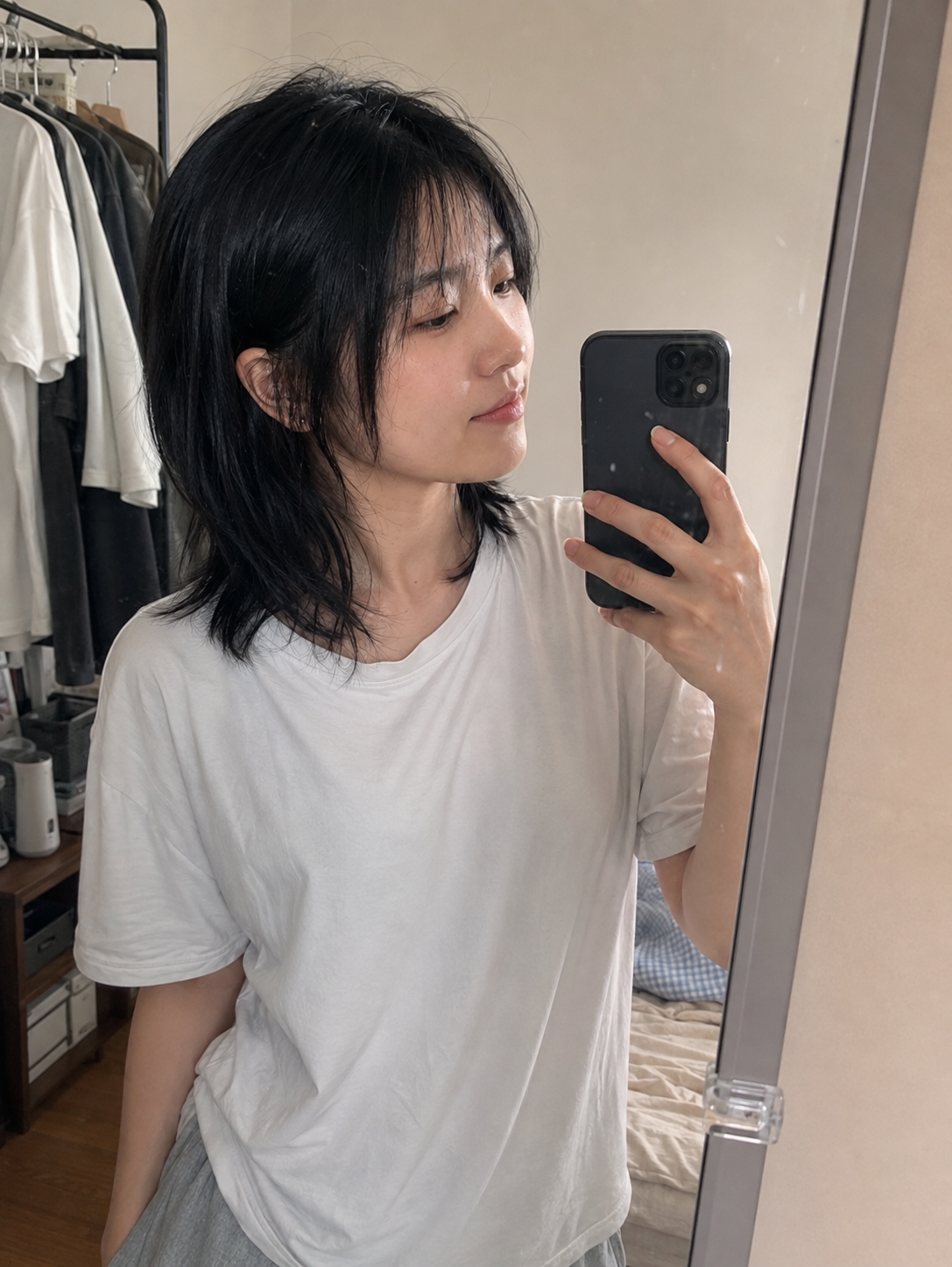 Natural upper-body mirror selfie in ambient light