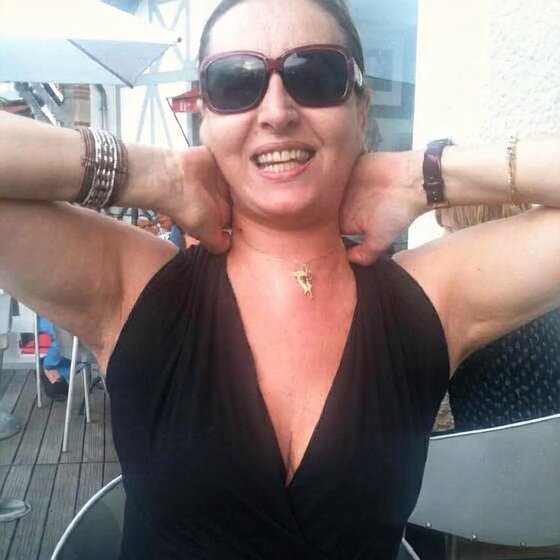 Smiling Woman at Outdoor Cafe