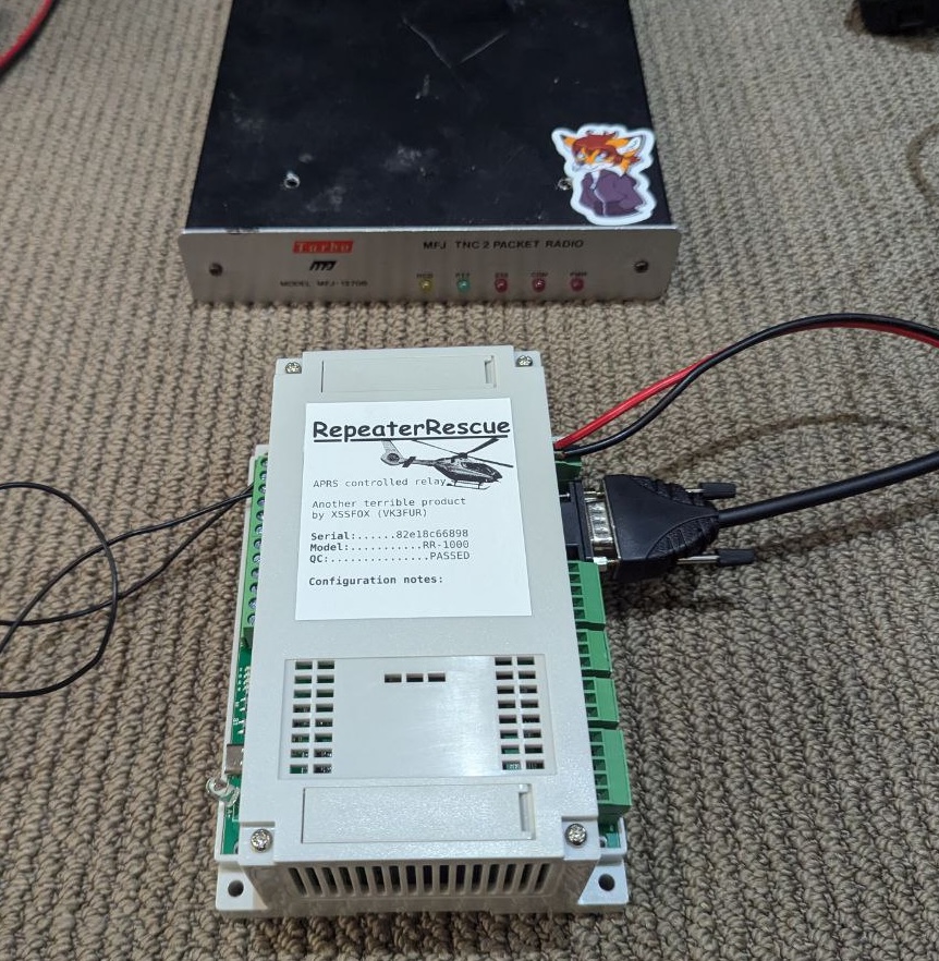 RepeaterRescue DIN mount box labeled with mac address. Connected via RS232 and power