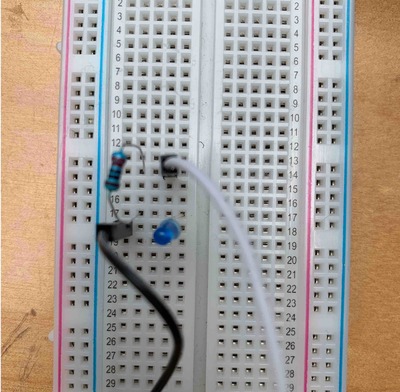 breadboard with LED, resistor, and jumper wires