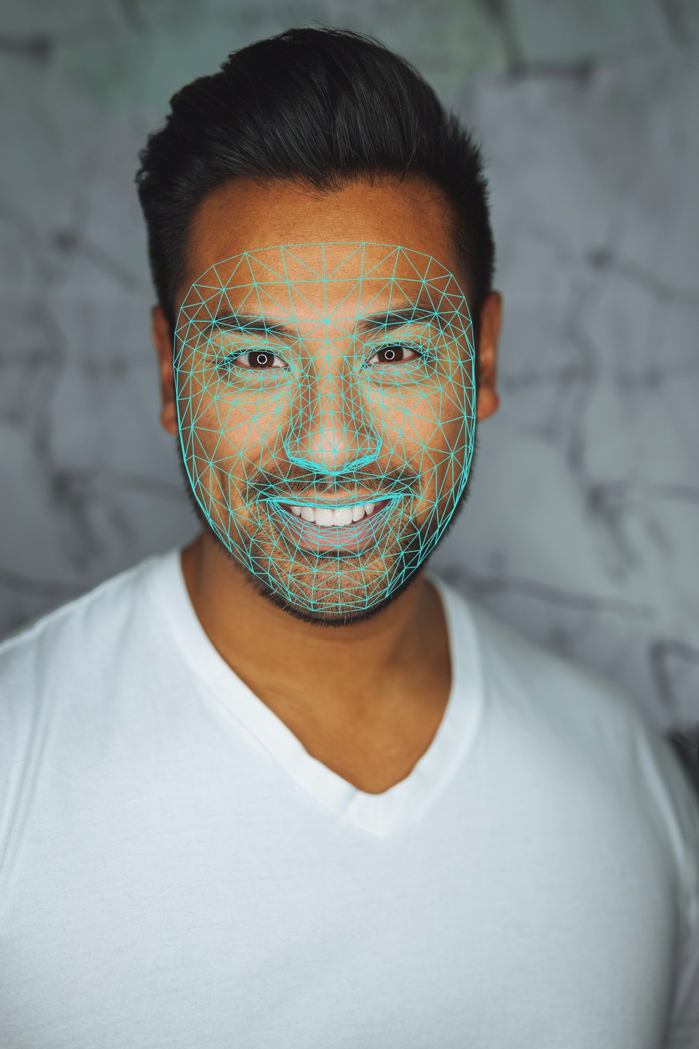 Dense 468-point face mesh overlaid on a smiling man