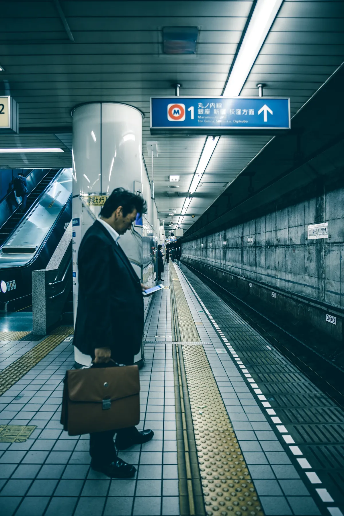 Tokyo subway entrance, the city behind it