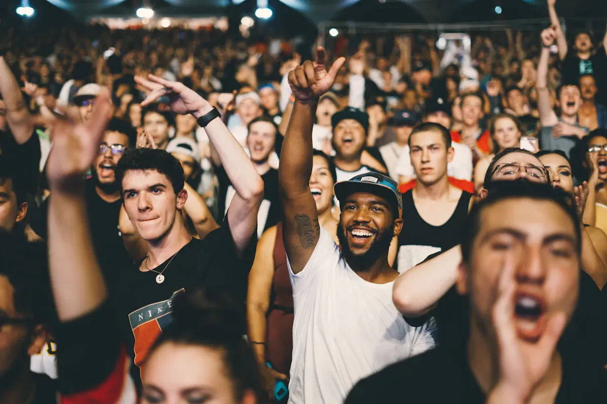A concert crowd with phones in the air, thousands voting with their attention