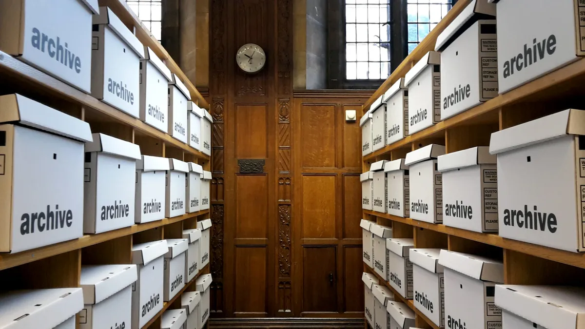 Rows of file folders and binders on shelves