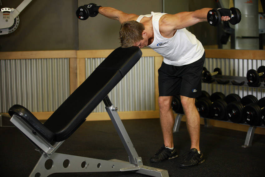 Bent Over Dumbbell Rear Delt Raise With Head On Bench finishing position