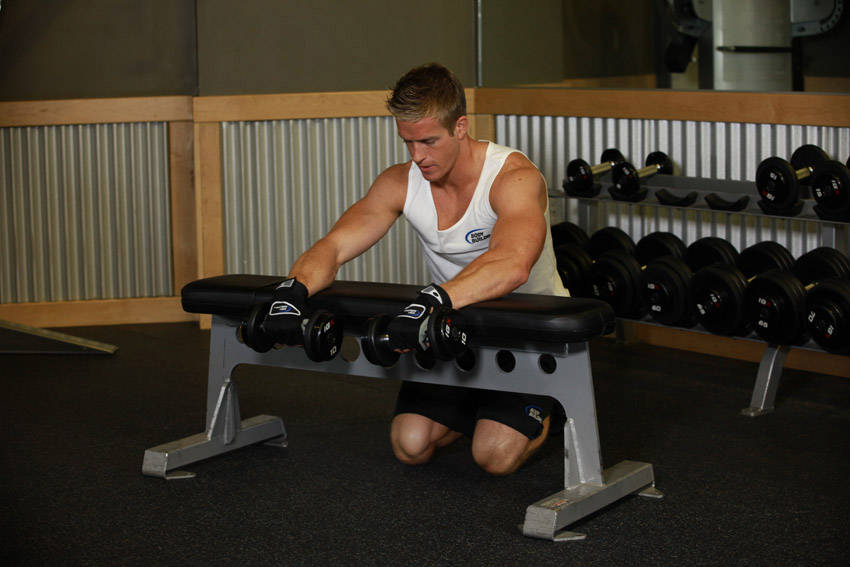 Palms-Down Dumbbell Wrist Curl Over A Bench reference position 1