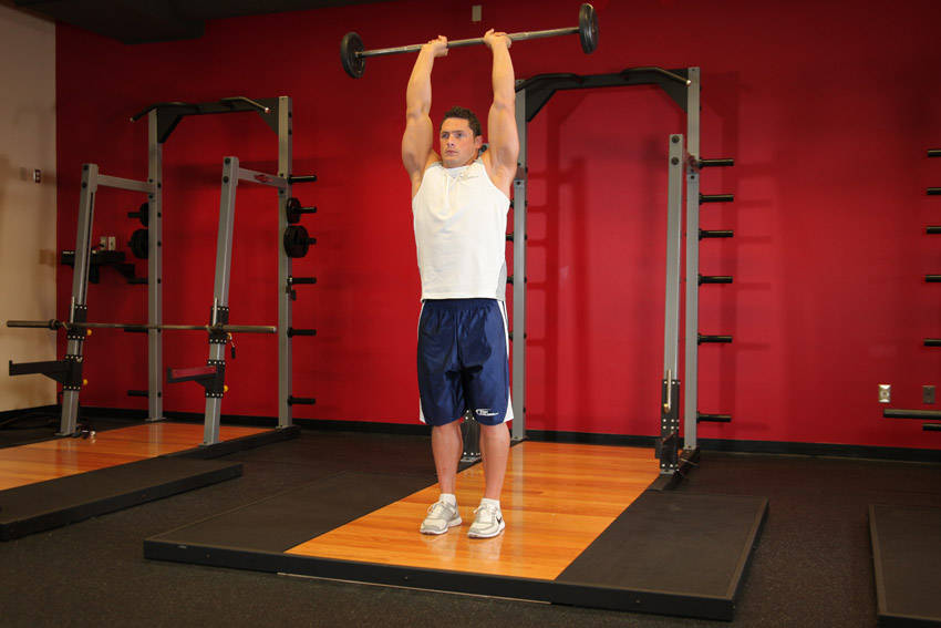 Ending position of Standing Overhead Barbell Triceps Extension